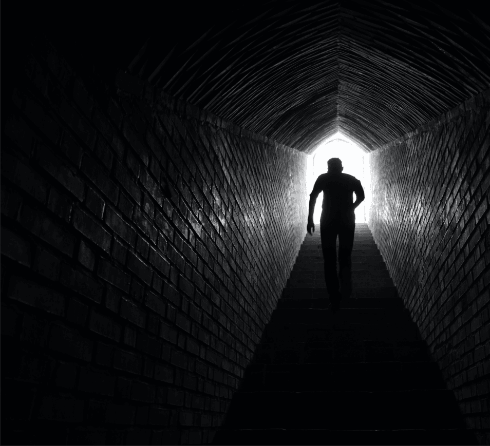 Man walking out of tunnel